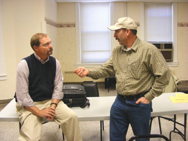Dr. Bruce Jones (left), University of Wisconsin-Extension farm management specialist, talking with Jim Marty at the Green County Dairy Management seminar in Monroe on Thursday, Jan. 8.