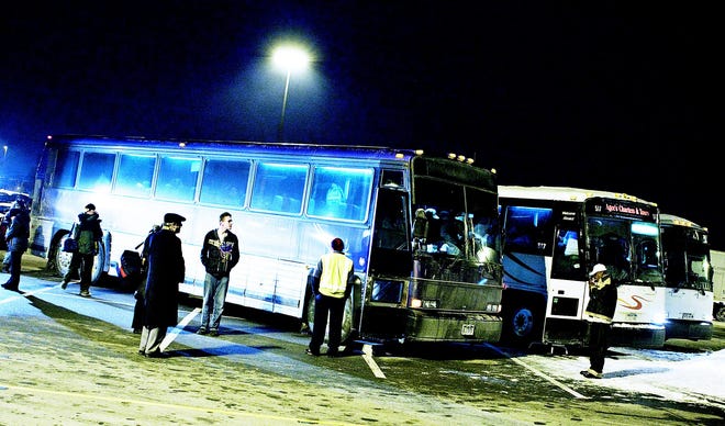 Folks from the group Rochester for Obama rush to catch their bus at the Wal-Mart in Henrietta on Monday, Jan. 19. About 141 folks from Monroe and Ontario counties boarded the three buses to hitch a ride to witness history.