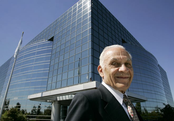Amar Gopal Bose, chairman and founder of Bose Corp., stands in front of the company's Framingham headquarters. The company, known for its high-end audio equipment, said yesterday it is cutting 1,000 job, about 10 percent of its global work force.