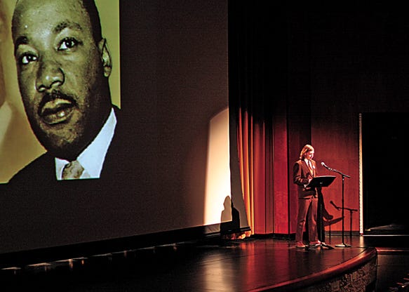 Simon Purdy, president of the LSSU Student organization for diversity — with photos of Martin Luther King Jr. displayed behind him — introduces a presentation at the beginning of the Martin Luther King Jr. celebration at Lake Superior State University Monday evening.