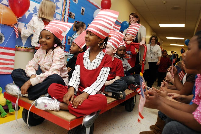 First graders Kya Lynon and Shatira Smith parade down the hallway at Center School on Tuesday, Jan. 20, 2009, during the school's own inaugural parade in honor of President Barack Obama organized by Barb Kerr's class.
