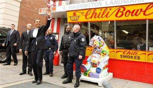 President-elect Barack Obama waves to onlookers as he leaves Ben's Chili Bowl where he stopped to eat with Washington Mayor Adrian Fenty in Washington, Saturday, Jan. 10, 2009. (AP Photo/Gerald Herbert)