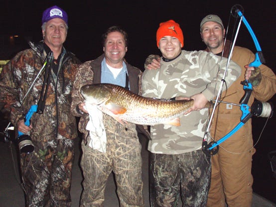 Landon Gauthier, third from left, shot this 37-pound red drum with a bow and arrow recently on a bow hunting trip with former Lieutenat Governor Paul Hardy, trail attorney David Groner of New Iberia and his father, Andre Gauthier of Gonzales.