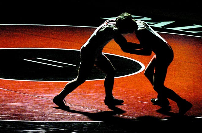 Palmyra-Macedon’s Mark Banker, left, takes on Canandaigua’s Owen Colegrove in the 152-pound weight class in a Finger Lakes East wresting match at Palmyra-Macedon on Thursday evening.