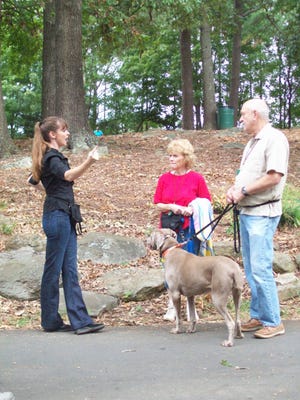 Victoria Stillwell, left, works on dog leash training with Debbie and Todd Rodgers and their dog Yaphit, a Weimaraner. A dog that pulls on a leash can spoil more than a nice walk.