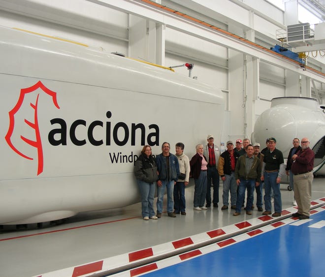 Some members of the tour group from northeast Illinois who visited the Acciona wind turbine assembly plant at West Branch, Iowa last Wednesday. Dennis Jepsen, the tour guide, is on the extreme right. The group is pictured by one of the nacelles that are located at the top of the assembled towers and enclose the shafts, gearbox, generator and control system.
