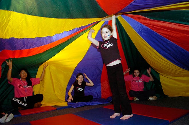 Amelia Keefe, 8, of East Bridgewater holds the center of a parachute during a recent birthday party at Stardust Gym in East Bridgewater.