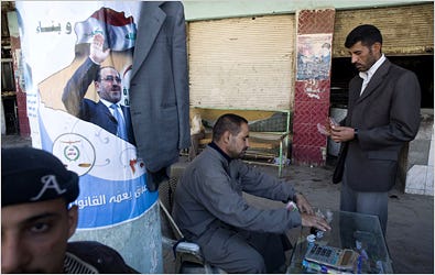 Prime Minister Nuri Kamal al-Maliki hopes his party will make gains in areas of southern Iraq like Diwaniya, where his poster hung behind a money changer.