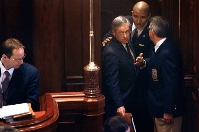 Former assistant U.S. attorney John Scully, center, is lead into the Illinois Senate chamber Monday, Jan. 26, 2009. Scully was the first witness to testify in the Senate impeachment trial of Illinois Gov. Rod Blagojevich. Scully spoke to the Senate about the process of getting permission for federal wiretaps. David Spencer/The State Journal- Register