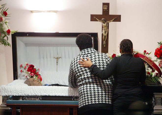 Friends and family mourn Arlindo Goncalves in front of his casket during his wake at Russell & Pica Funeral Home in Brockton on Tuesday. Goncalves, a Cape Verdean immigrant, was shot to death last week by Keith Luke, police say. Police say Luke was on a shooting rampage to kill  nonwhites in Brockton.