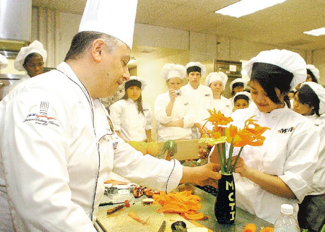 Ebony Lambert-Smith gets a chance to learn how to create a bouquet of vegetable flowers from Chef Antonios K. Boulos of Almond Tree Manor in Alpha, N.J., during a class at MCTI.