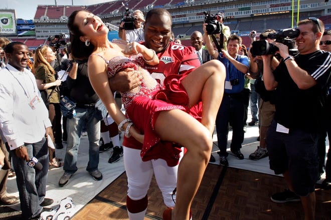 Arizona Cardinals defensive tackle Gabe Watson dances with Renee Sapp during the team's media day for Super Bowl XLIII Tuesday, Jan. 27, 2009, in Tampa, Fla. The Cardinals will play the Pittsburgh Steelers in the NFL Super Bowl football game on Sunday, Feb. 1.