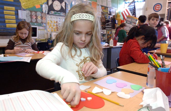 Josie Reed and her classmates from Judy McCauley's second grade class at Wilder-Waite grade school make Valentine's day cards Wednesday afternoon for wounded soldiers at Walter Reed Army Medical Center in Washington D.C.