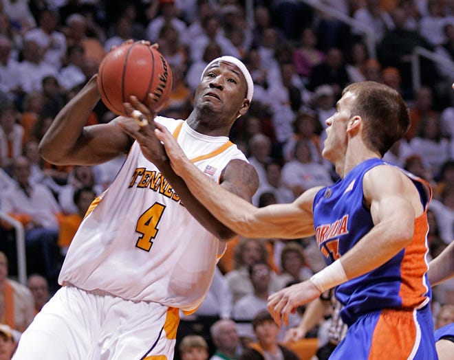 Tennessee’s Wayne Chism (4) is fouled by Florida’s Nick Calathes during the first half Saturday in Knoxville, Tenn.