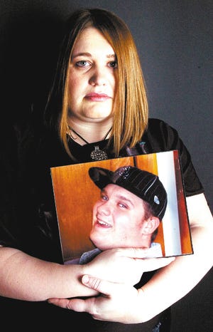 Meg Watt of Stroudsburg holds a picture of her late brother, Michael Hopkins. Hopkins died of exposure to carbon monoxide.