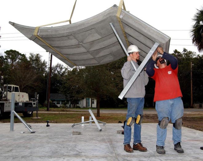 TERRY DICKSON/The Times-UnionWorkers Bobby Hodges (left) and Don Wimer attach supports to concrete that will be part of Glynn County's new skate park at Demere Park.