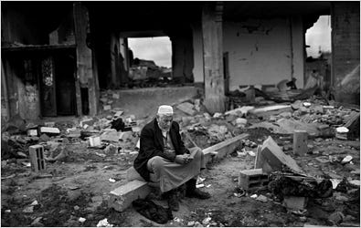 Niam Midri, 63, in front of his destroyed house in El Atatra.