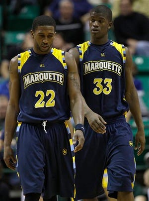 Marquette's Jerel McNeal (22) and Jimmy Butler walk back to the bench for a time-out during an NCAA college basketball game against South Florida, Friday, Feb. 6, 2009, in Tampa, Fla. South Florida upset Marquette 57-56.