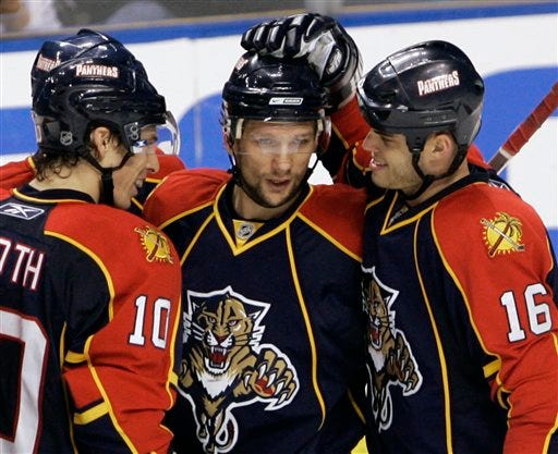 Florida Panthers forward Richard Zednik, center, of Slovakia, is congratulated by forwards David Booth, left, and Nathan Horton after Zednik scored a goal during the second period of an NHL hockey game against the New York Islanders on Thursday, Feb. 5, 2009, in Sunrise, Fla.