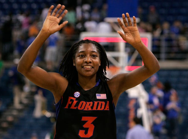 After scoring 29 points and grabbing 7 rebounds, Florida's Sha Brooks waves to the crowd of more than 8,000 as she exits the O'Connell Center to a standing ovation.