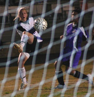 Dutchtown’s Chelsea Cruthirds takes a shot on goal ahead of Westgate’s Kathy Huynh in the first half of the Lady Griffins’ 2-0 Division I bi-district playoff victory Friday night.