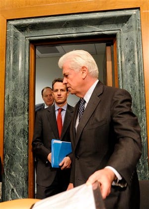 Treasury Secretary Tim Geithner, center, followed by the Senate Banking Committee's ranking Republican Sen. Richard Shelby, R-Ala., walks toward Committee Chairman Sen. Chris Dodd, D-Conn., on Capitol Hill in Washington, Tuesday, Feb. 10, 2009, prior to the start of the committee's hearing that Geithner testified before.