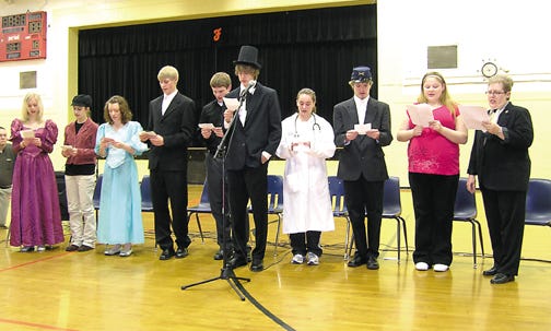 Flanagan-Cornell High School students in Bev Hart’s Honors American Studies class celebrated Abraham Lincoln’s 200th birthday this morning by presenting a “This is Your Life” about Lincoln to sixth grade through high school students at Flanagan. From left are Emily Gundy portraying Mary Todd Lincoln, Marissa Barton as Owen Lovejoy, Jenna Rients as Harriet Beecher Stowe, Ben Roeschley as Frederick Douglass, Cody Schwerin as Edward Everett, Jacob Hall as Lincoln, Roxanne Gourley as Clara Barton, Caleb Friend as Ulysses Grant, Angelica Hernandez as the narrator, and Hart, who introduced each guest.