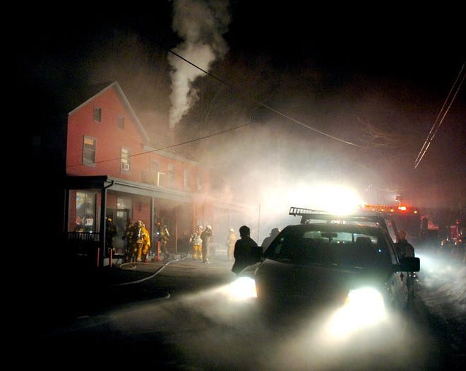 Smoke fills the air as firemen battle the blaze at the Minisink Hotel on Sunday night.