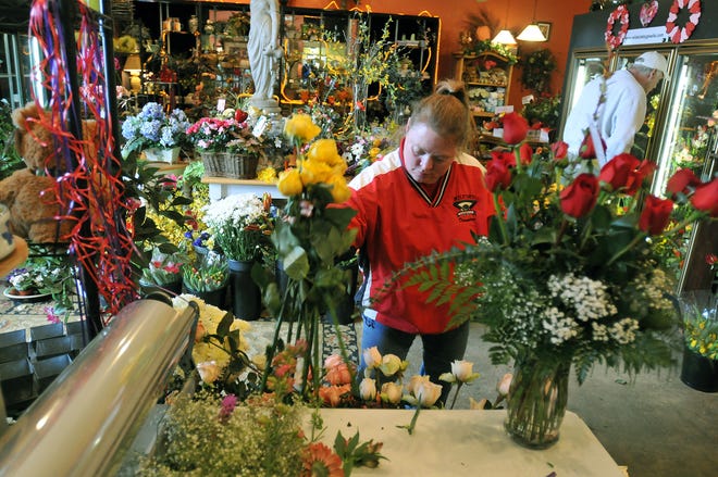Maureen Hutchins creates a bouquet at "The Wild Side" in Milford, Saturday.