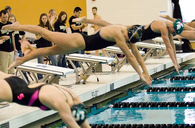 Contributed/Purdue University
Purdue University’s Lisa Butler, left, dives in to swim the 50-yard freestyle at a meet this year. Below, Butler swims in practice. The Holland graduate has experienced several changes during her sophomore season.