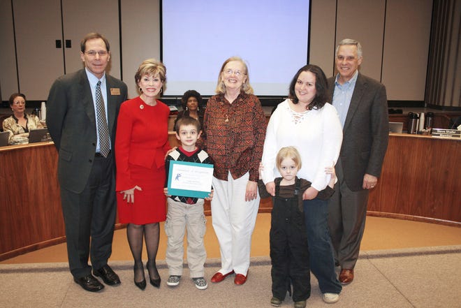 Gage Zachary, center, is with, from left, Oklahoma City Superintendent Karl Springer; state Superintendent Sandy Garrett; art teacher Marcia Greenwood; his mother, Aianna Zachary; brother, Gavin Zachary; and Kirk Humphreys, former school board chairman. The school board honored Gage for his win in the primary division of the National Parent Teacher Association’s My Family Dinner art contest. PHOTO PROVIDED BY OKLAHOMA CITY SCHOOL DISTRICT