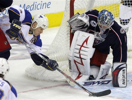 Columbus Blue Jackets' Steve Mason, right, makes a save against St. Louis Blues' Keith Tkachuk, top left, during the third period of an NHL hockey game Wednesday, Feb. 18, 2009, in Columbus, Ohio. The Blue Jackets defeated the Blues 4-3. (AP Photo/Jay LaPrete)