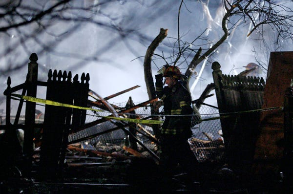 A fireman walks past the remains of a house on New York Avenue in Somerset, Mass., after a natural gas explosion, Thursday, Feb. 19, 2009. Oe person was confirmed dead in the explosion that happened around 6:30 p.m.