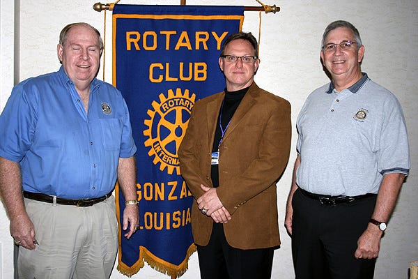 Principal Randy Watts of East Ascension High School, center, was joined by Rotary Club of Gonzales President Mark LaCour, right, and Rotarian Loyson Porta during the club meeting Feb. 10. Watts explained how the school is fostering a love of reading in its students through its sustained silence reading program.
