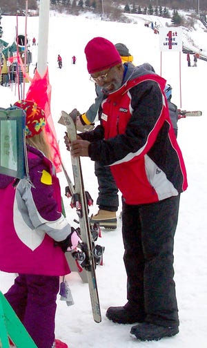 Skiing instructor Hamilton Banks works with a young beginner.