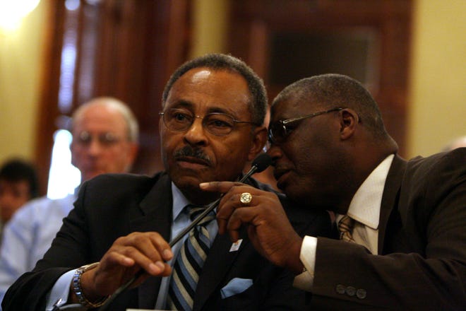 U.S. Senate appointee Roland Burris, left, listens to his attorney Timothy Wright while testifying during the Illinois House Impeachment Committee hearing at the Illinois State Capitol Thursday, Jan. 8, 2009. T.J. Salsman/The State Journal-Register