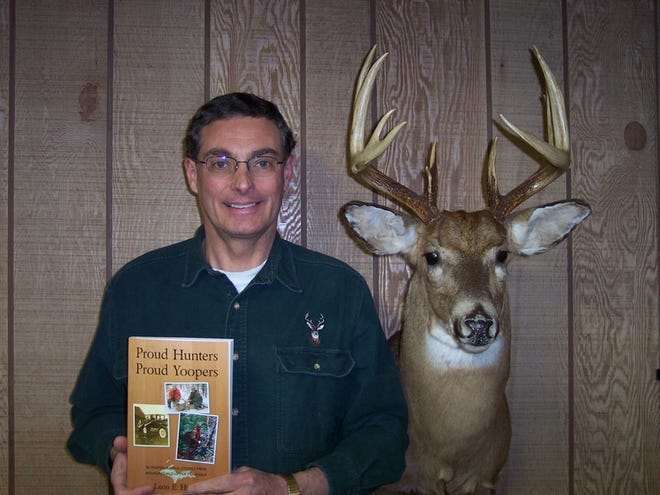 Leon Hank proudly shows off his new book, "Proud Hunters, Proud Yoopers"