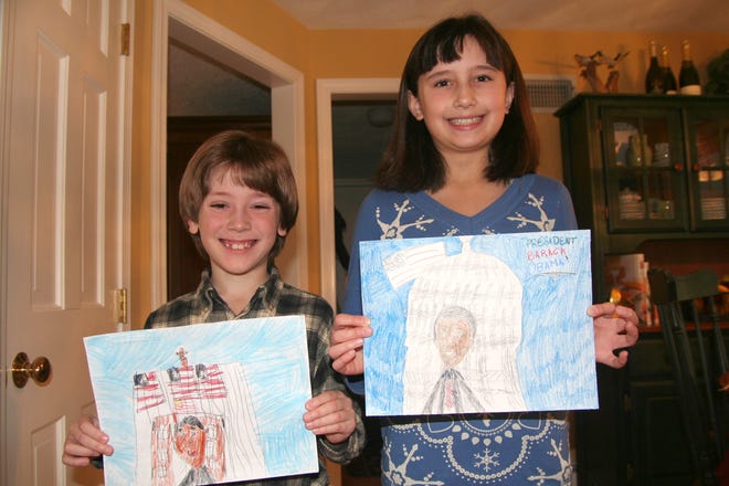Holliston siblings Billy and Erika Bridges hold up the drawings of President Barack Obama they submitted in a recent national contest.