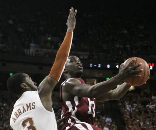 Oklahoma guard Willie Warren shoots past Texas guard A.J. Abrams, left, during the first half of an NCAA men's college basketball game Saturday, Feb. 21, 2009, in Austin, Texas. (AP Photo/Harry Cabluck)
