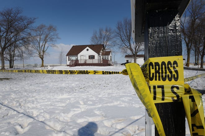 Police tape surrounds the Zeeland Township home of Bill Olbert Monday, where he was killed by a sheriff’s deputy Sunday night. Olbert stabbed his estranged wife at her workplace Sunday, then fled to his home. Police found the home in flames before a deputy fired the shots that killed Olbert.