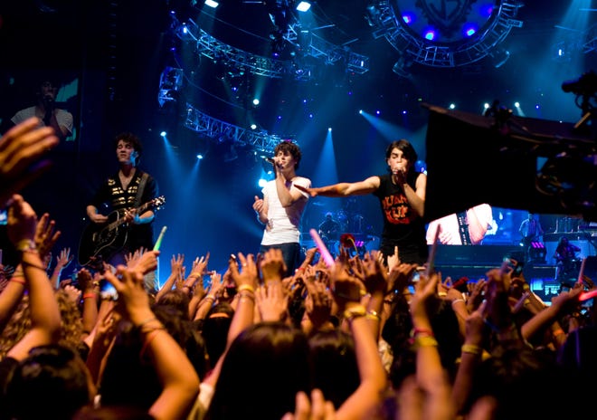 In this image released by Disney, the Jonas Brothers -- from left, Kevin, Nick and Joe -- perform in the film, "Jonas Brothers: The 3D Concert Experience."