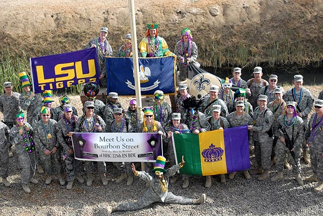 Members of the Louisiana National Guard’s 225th Engineer Brigade pose in front of their headquarters Feb. 24. The soldiers didn’t let a deployment to Iraq stand in their way of celebrating Mardi Gras this year.