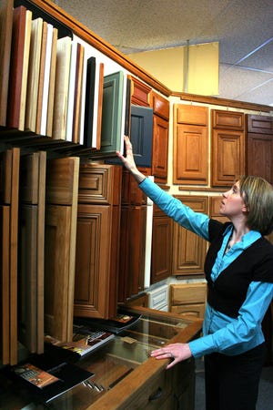 Lindsay Heitz shows the variety of cabinet door styles at Floor to Ceiling in Freeport.