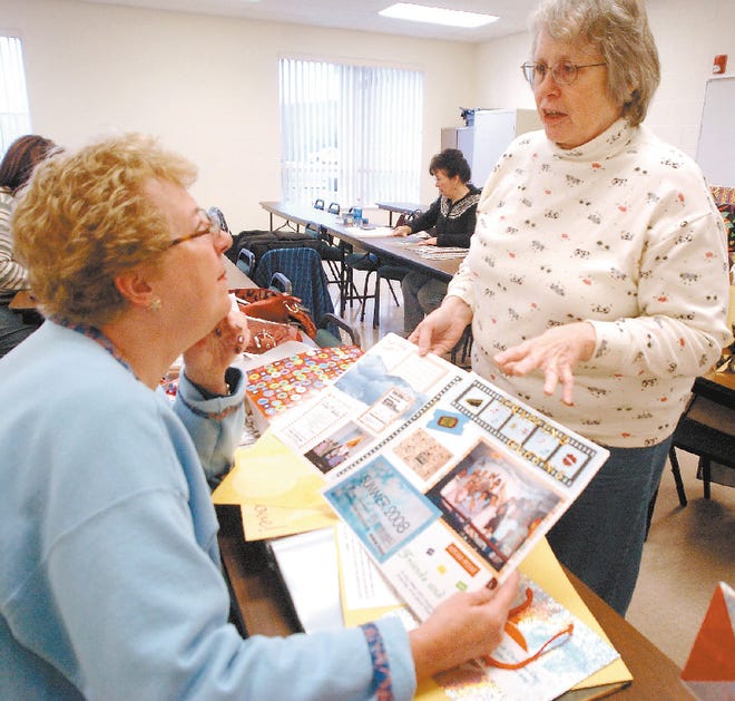 Bev Place of Marshalls Creek, left, admires the scrapbooking work of Mary Lindauer of Reeders during Craft Central class at Monroe County Safety Center in Snydersville. To purchase a print of the photo, go to www.PoconoRecord.com/photostore.