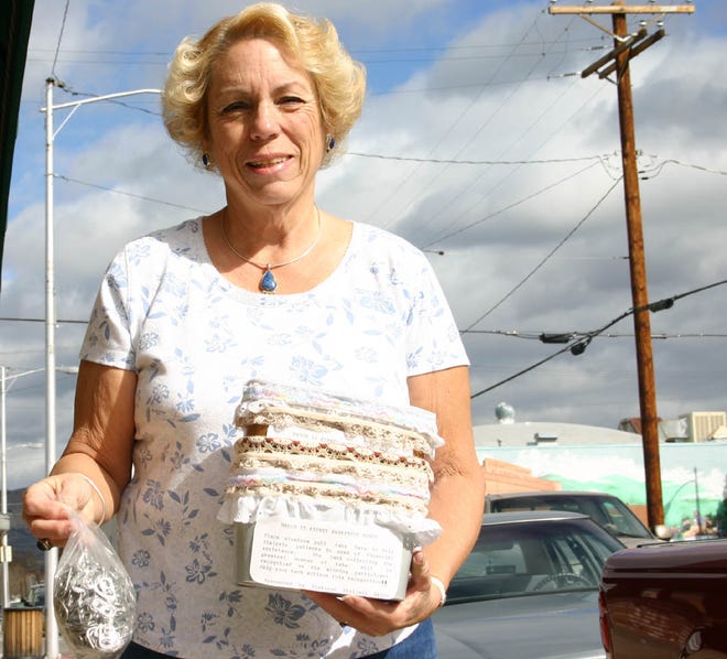 Linda Stone holding a bag of pull tabs along with the containers to be distributed at local banks. For more information, call 842-1990.