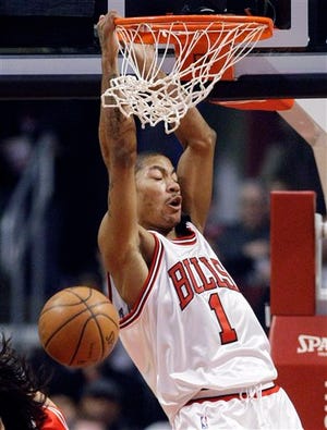 Chicago Bulls guard Derrick Rose dunks the ball during the first half of their NBA basketball game against the Houston Rockets in Chicago, Saturday, Feb. 28, 2009.