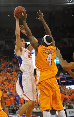 PHIL SANDLIN/Associated PressFlorida's Chandler Parsons (left) tries to get the ball past Tennessee's Wayne Chism during the first half of Sunday's game in Gainesville.