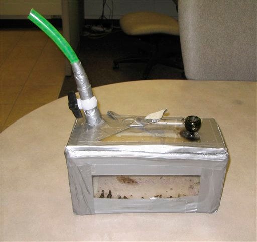 A homemade bong, consisting of a piece of garden hose attached to a duct-taped plexiglas box, is seen in this March 1, 2009, handout photo provided by the Lancaster County Sheriff's Dept. Deputies responding Sunday, March 1, 2009, to a domestic disturbance call at a Lincoln, Neb., area residence, cited a 20-year-old man on suspicion of animal cruelty after catching him smoking marijuana from the contraption that had Shadow, a six-month-old female cat, stuffed inside its 12-inch by 6-inch base. The man told deputies the cat had been acting hyper and that he was trying to calm her down.