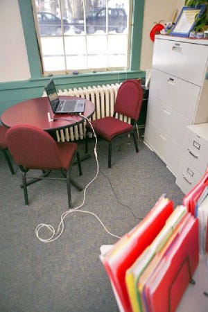 A laptop serves as an Internet work station at Sandwich Town Hall because desktop computers have been deemed a security risk.