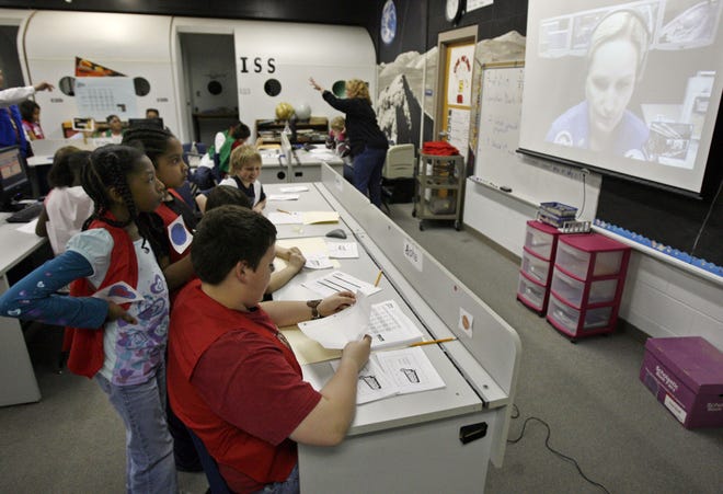Braiden Marcotte, 10, center, transmission specialist for Operation Dark Sky, relays the information given by team members Jazmin Williams, 10, near left, and Alyssa Gentry, 11, to the Challenger command officer with NASA. The fifth-grade students at Williams Science and Fine Arts Magnet worked with NASA in an exercise to find a lost astronaut.